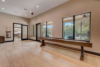 a large living room with a large window and a wooden bench